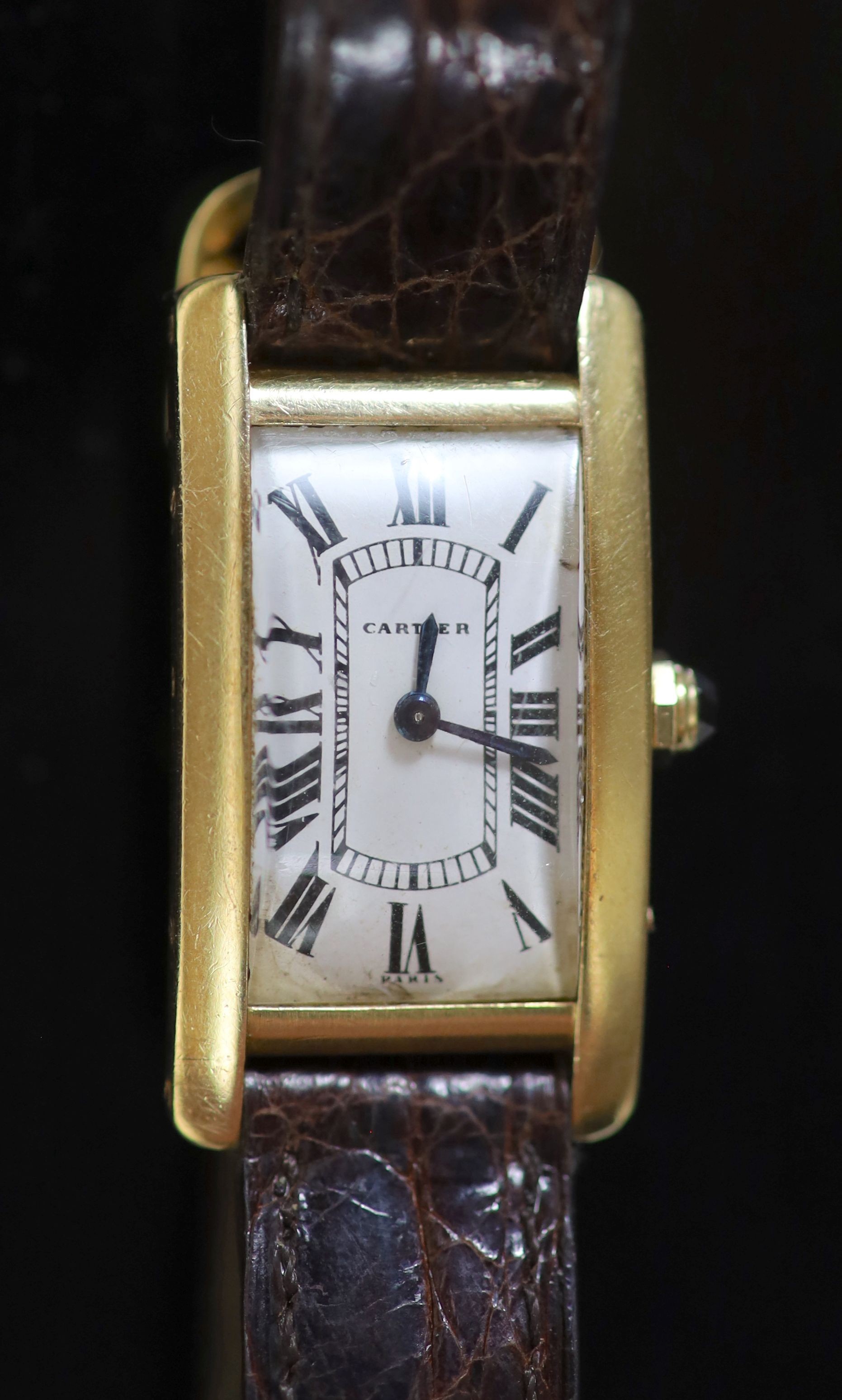 A lady's French 18ct gold Cartier Tank Americaine manual wind wrist watch, on a gold mounted Cartier leather strap, with deployment clasp